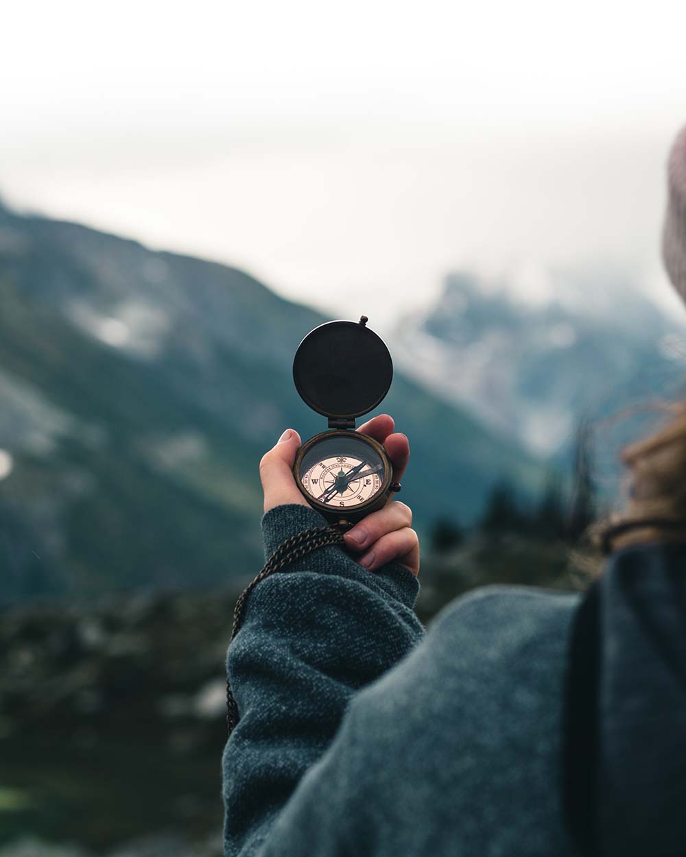 hand holding compass